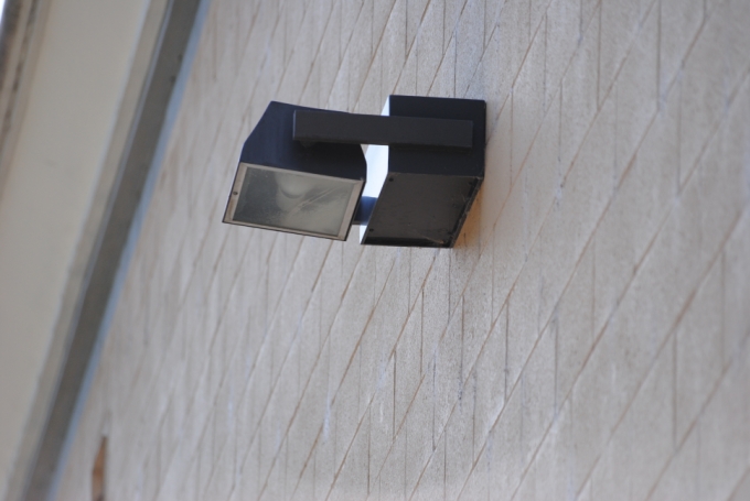 LED wall pack fixture mounted on a building