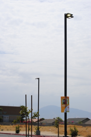 Parking lot light pole against an evening sky
